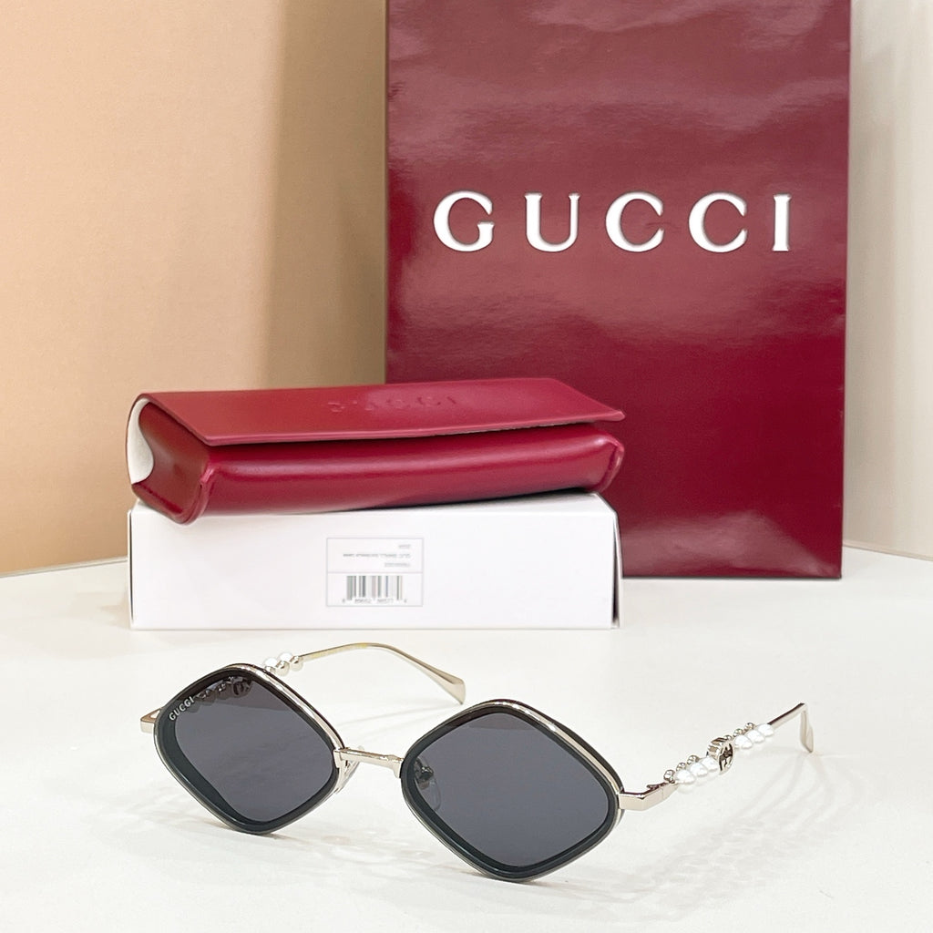 Gold round sunglasses with dark lenses and pearl beaded temple accents
