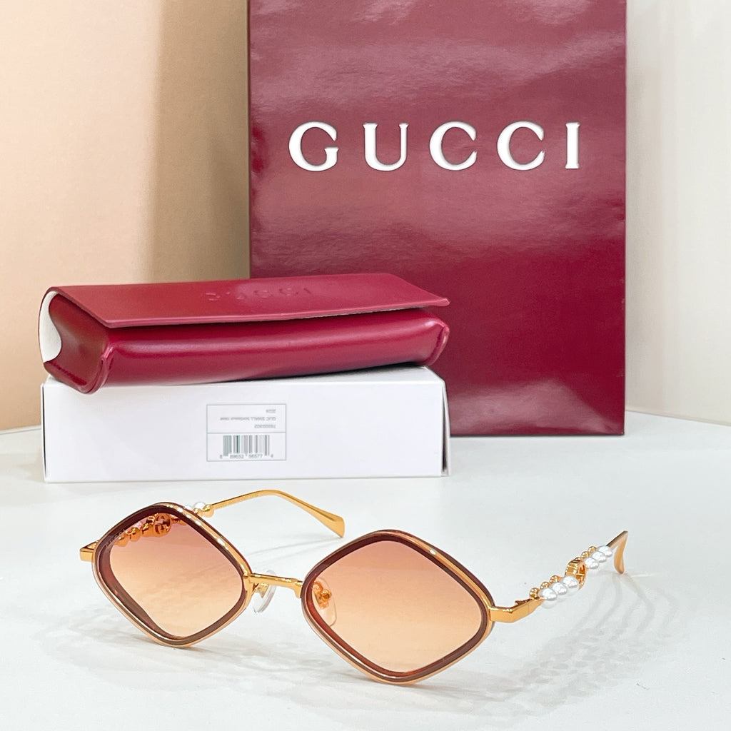Gold round sunglasses with amber-tinted lenses and pearl beaded temple accents