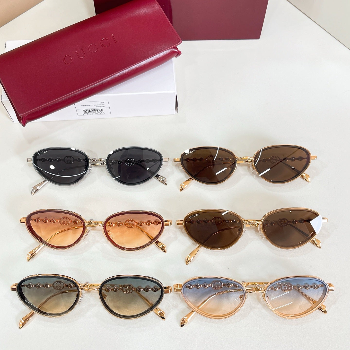 Gucci sunglasses assortment with multiple frames and tinted lenses, oval shapes with pearl accents