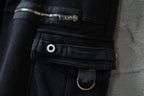 Dark cargo pants waist detail with elastic band, belt loop, snap button, and ring strap