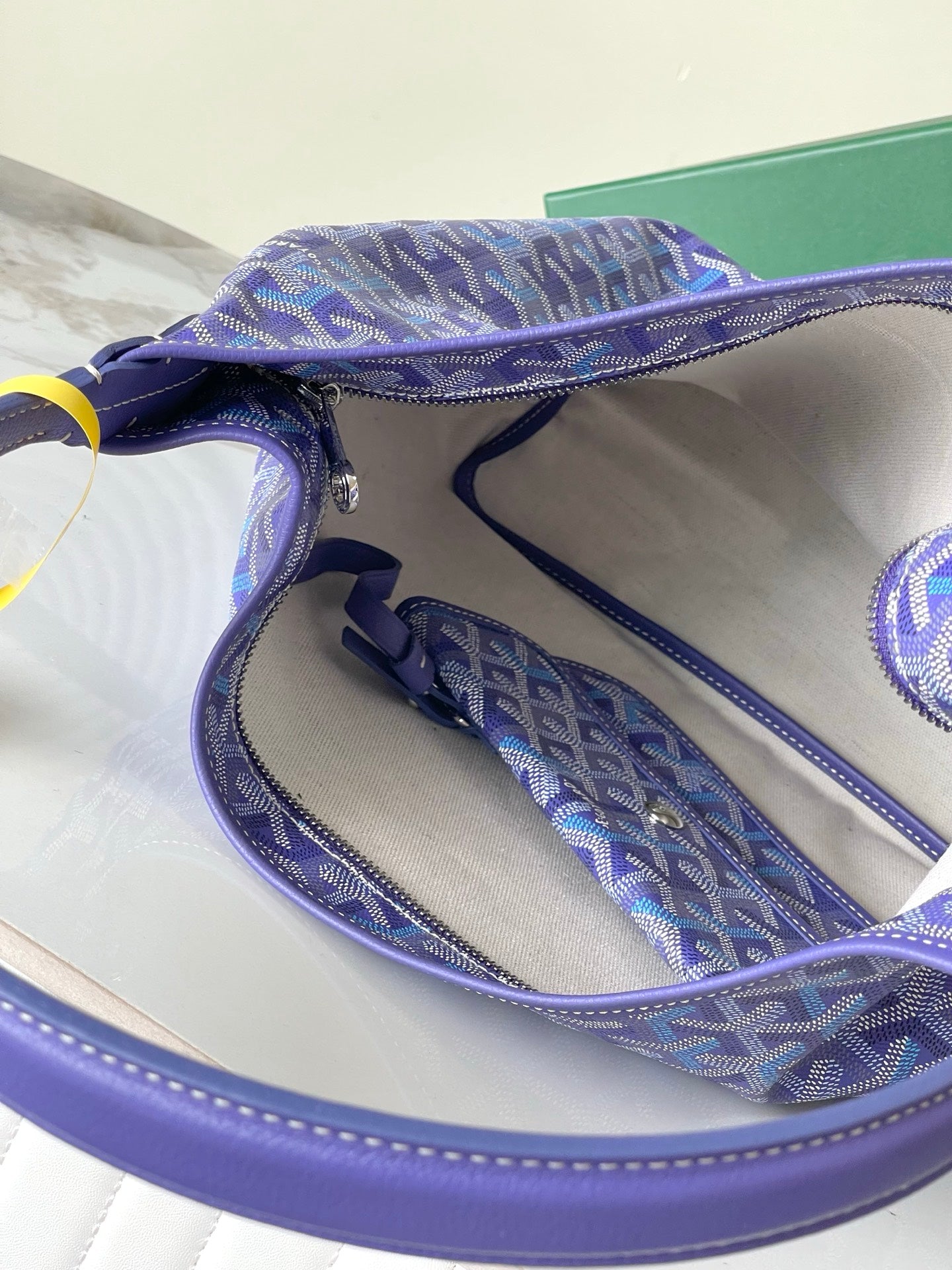 Purple patterned hobo bag interior with zipper and rolled leather opening edge