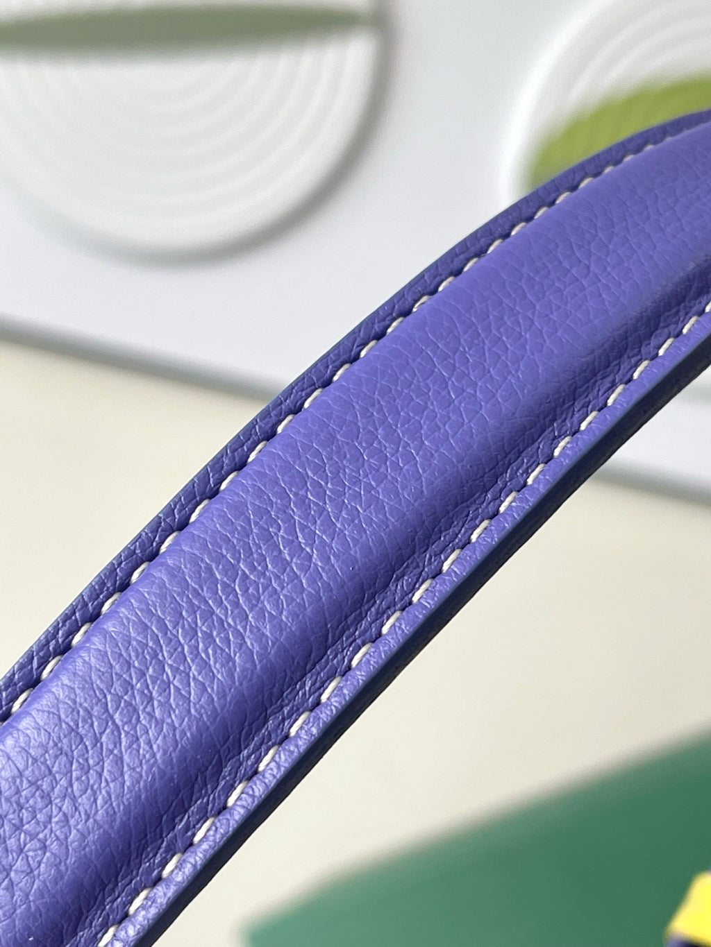 Close-up of purple leather strap with contrast stitching