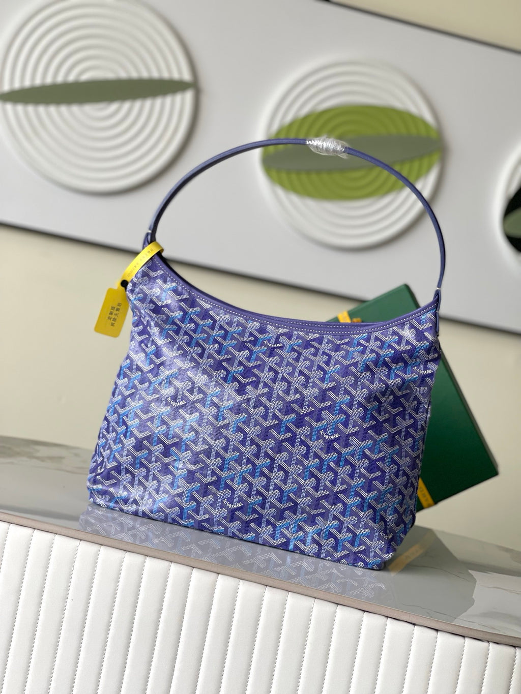 Purple patterned hobo bag with round handle and yellow accents, front view