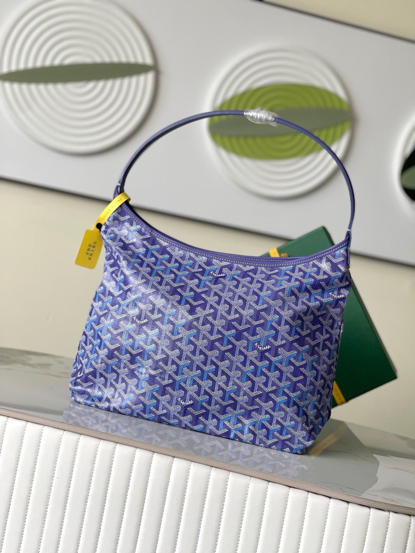 Purple patterned hobo bag with round handle and yellow accents, front view