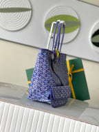 Blue patterned tote bag with long strap and attached small zip pouch