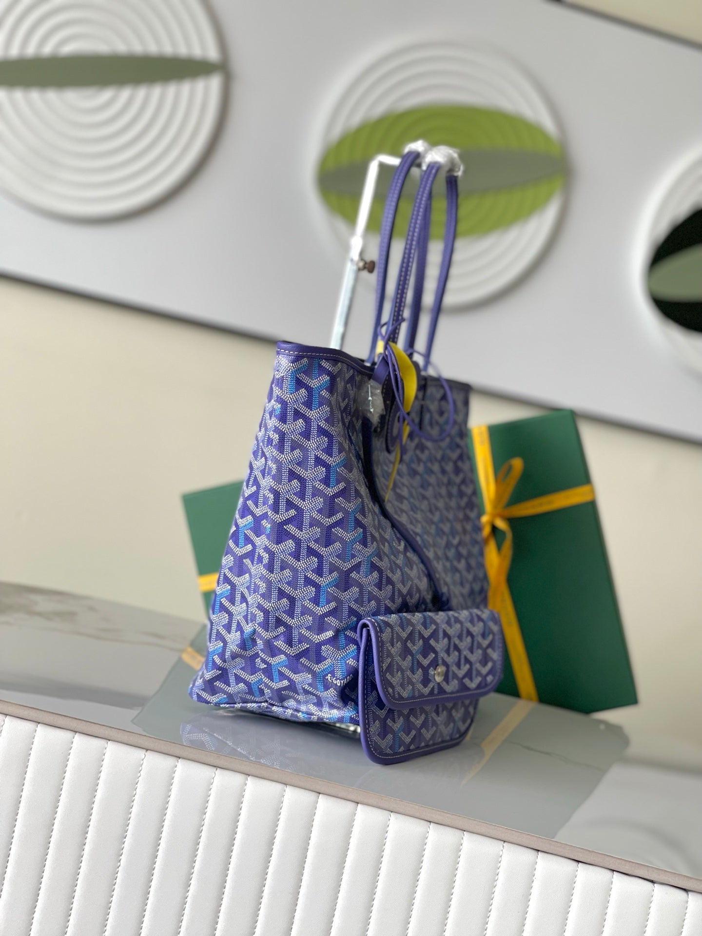 Blue patterned tote bag with long strap and attached small zip pouch