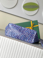 Blue patterned zip pouch with leather trim and bow tie closure