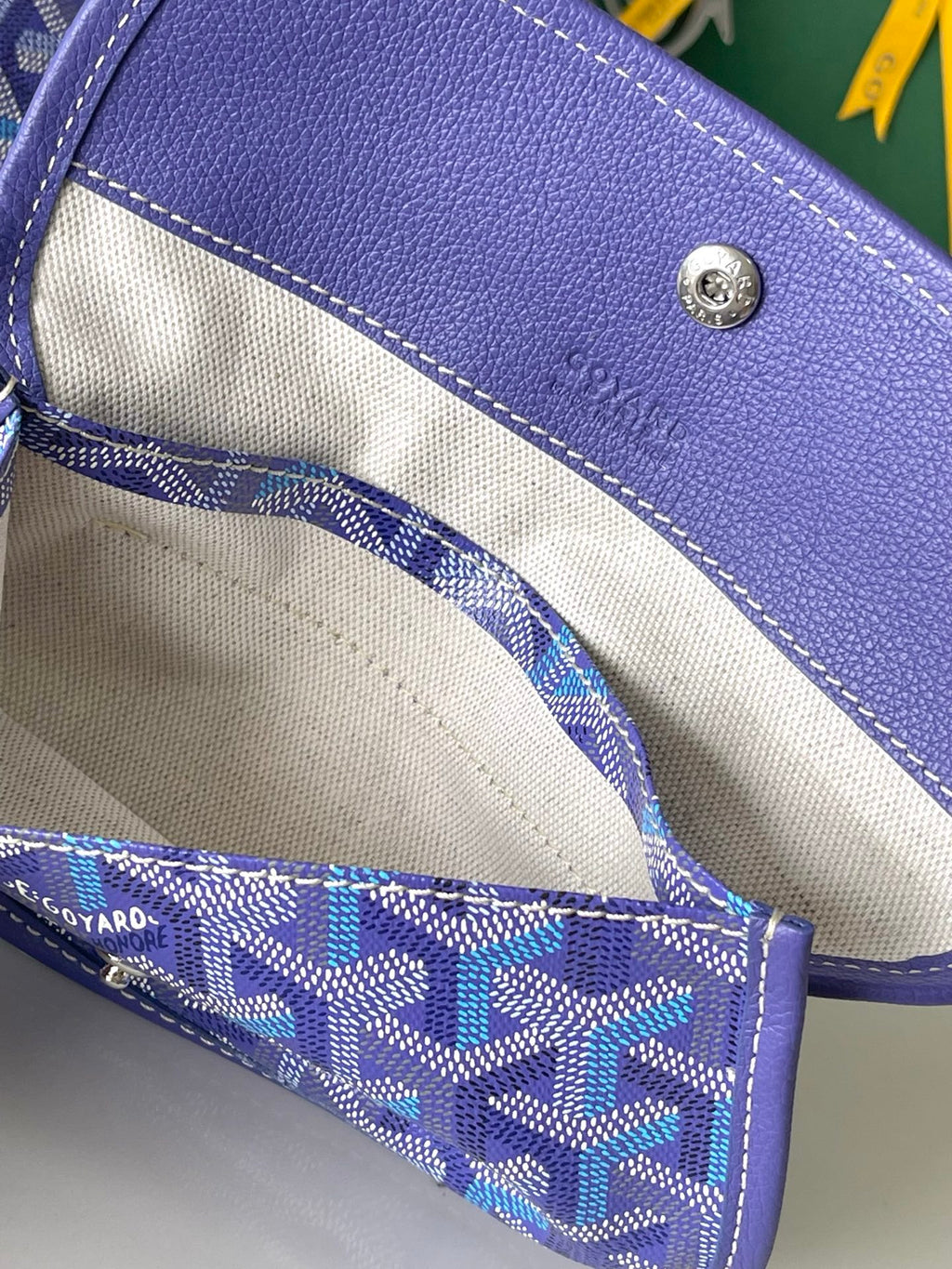 Blue patterned interior pocket with fabric lining and stitched top edge