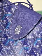 Blue patterned pouch with textured leather flap and circular logo emblem