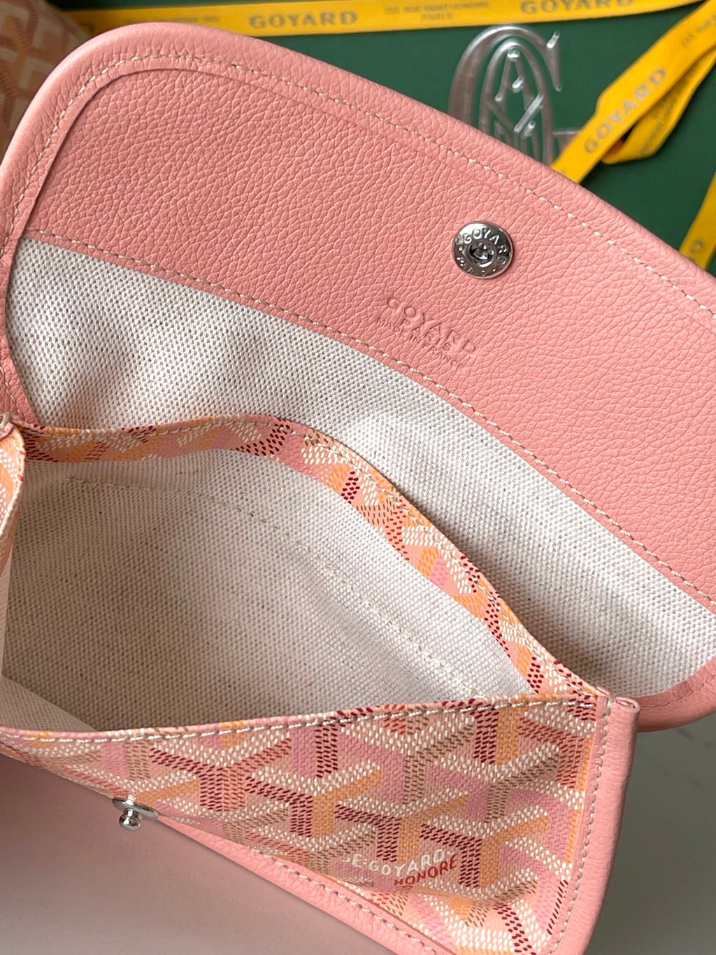 Goyard tote bag interior with pink trim, beige lining, and small zip pocket