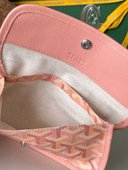 Goyard tote bag interior with pink trim, beige lining, and small zip pocket