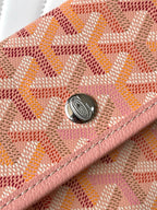 Pink patterned flap with metal snap and circular emblem detail