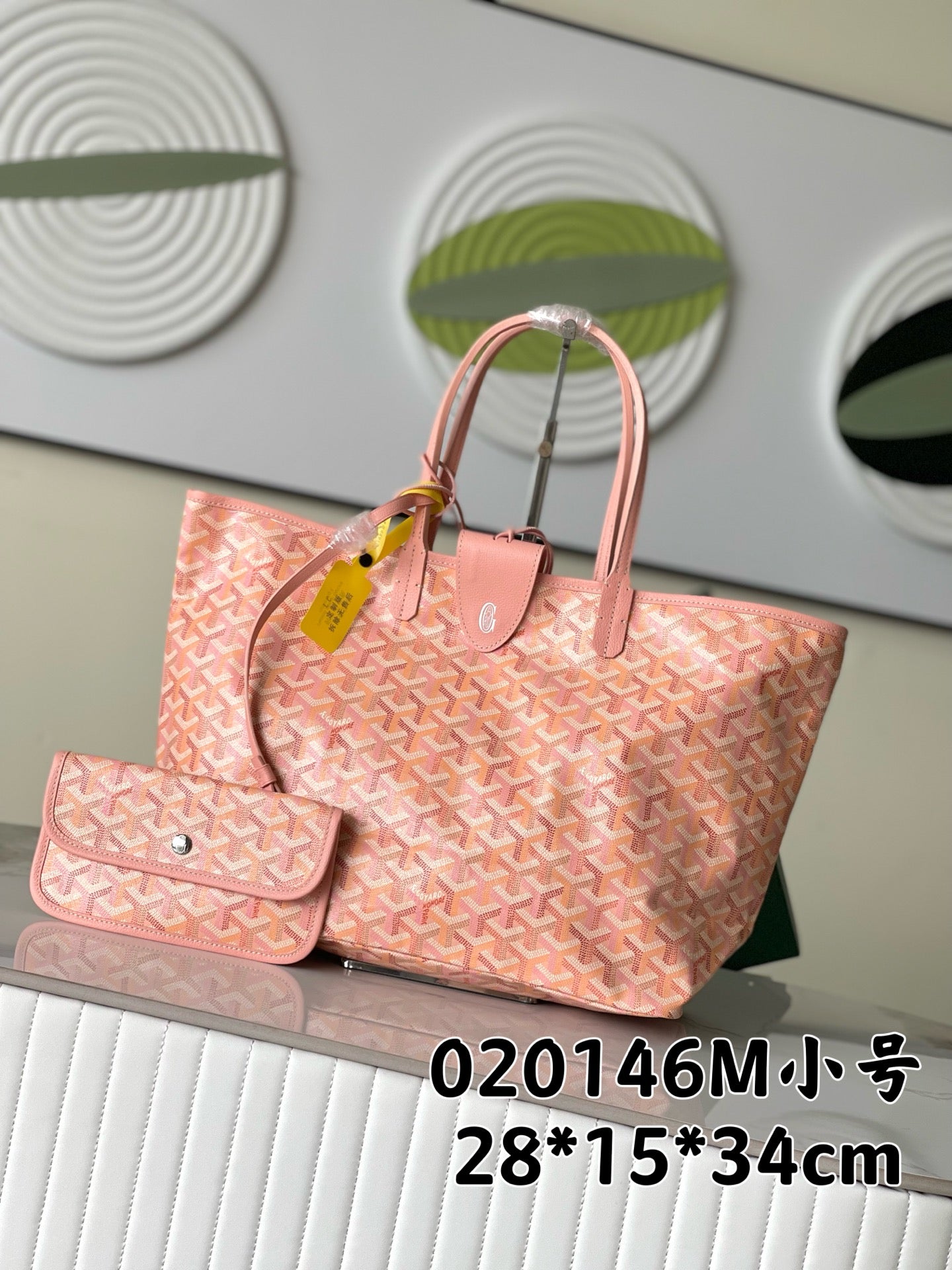 Goyard patterned tote bag in pink with dual handles and matching front pouch