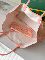 Goyard tote bag open interior with pink trim, beige lining, and zip pocket