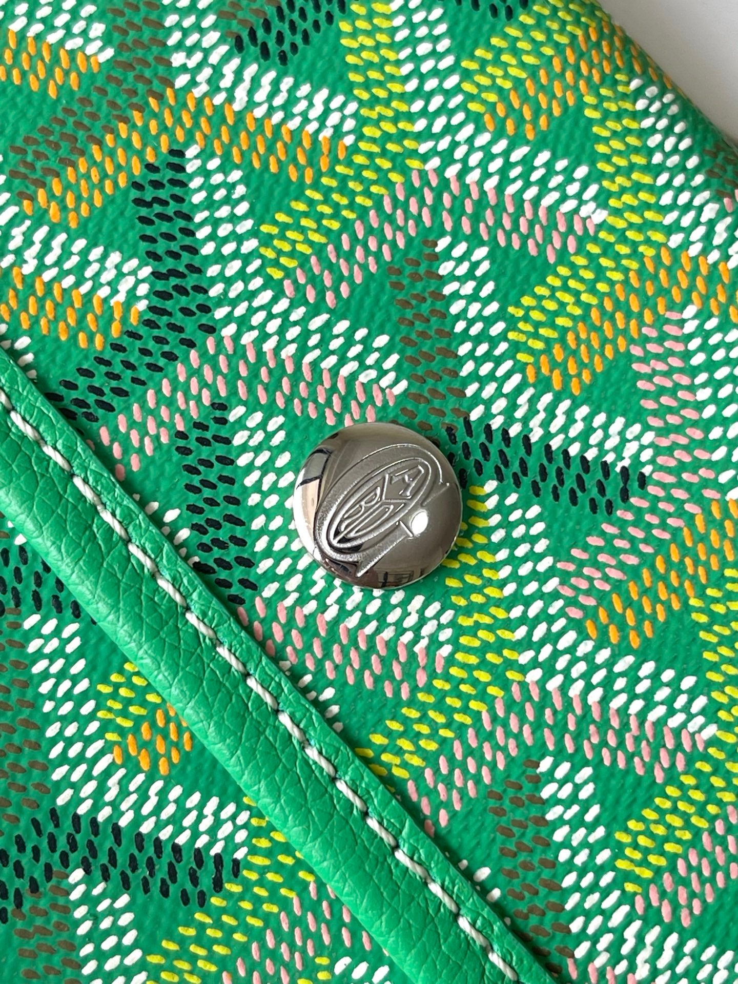 Snap button on green patterned tote bag pocket