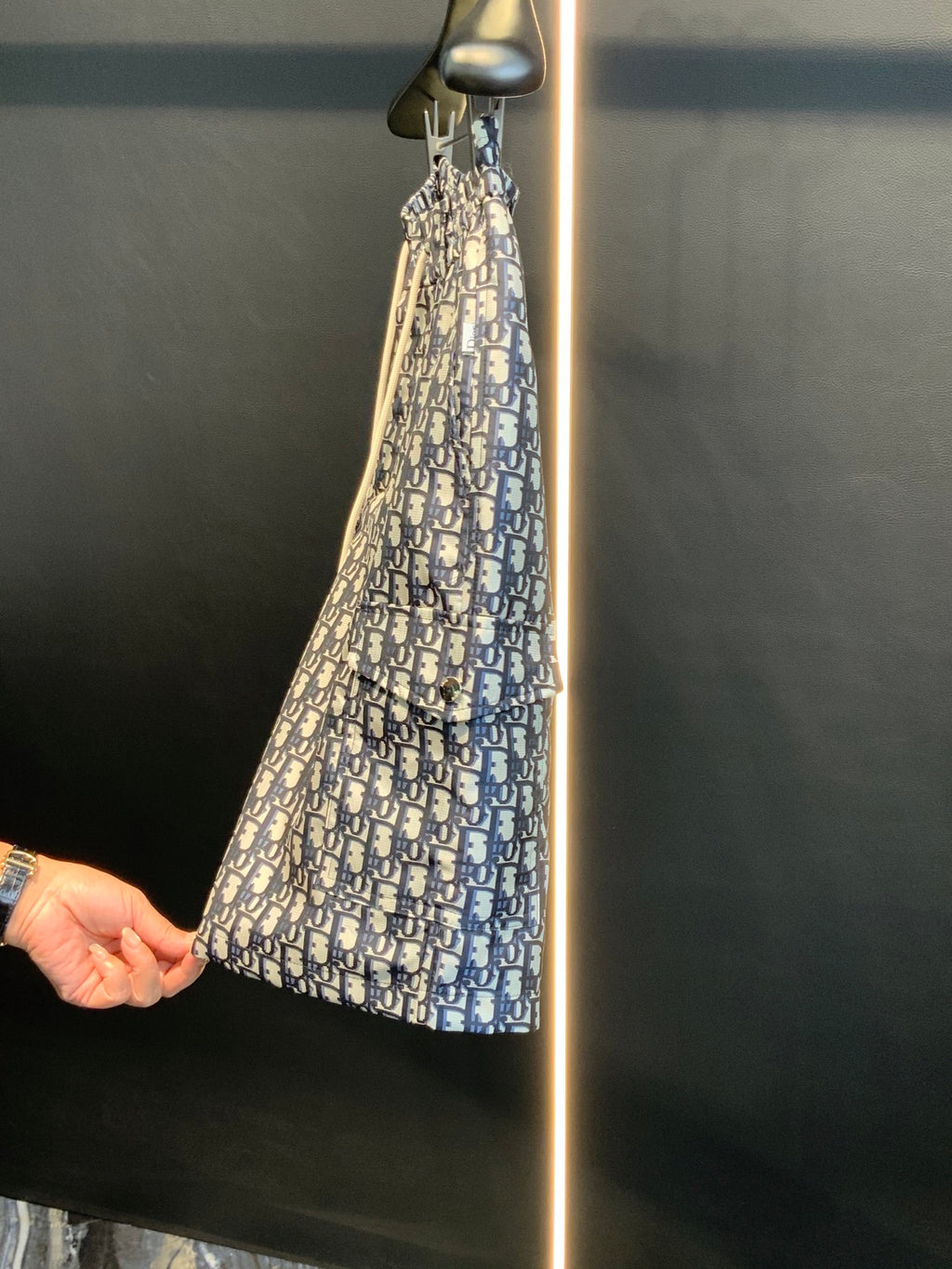 Dior monogram print shorts on hanger, angled view, blue and cream