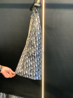 Dior monogram print shorts on hanger, angled view, blue and cream