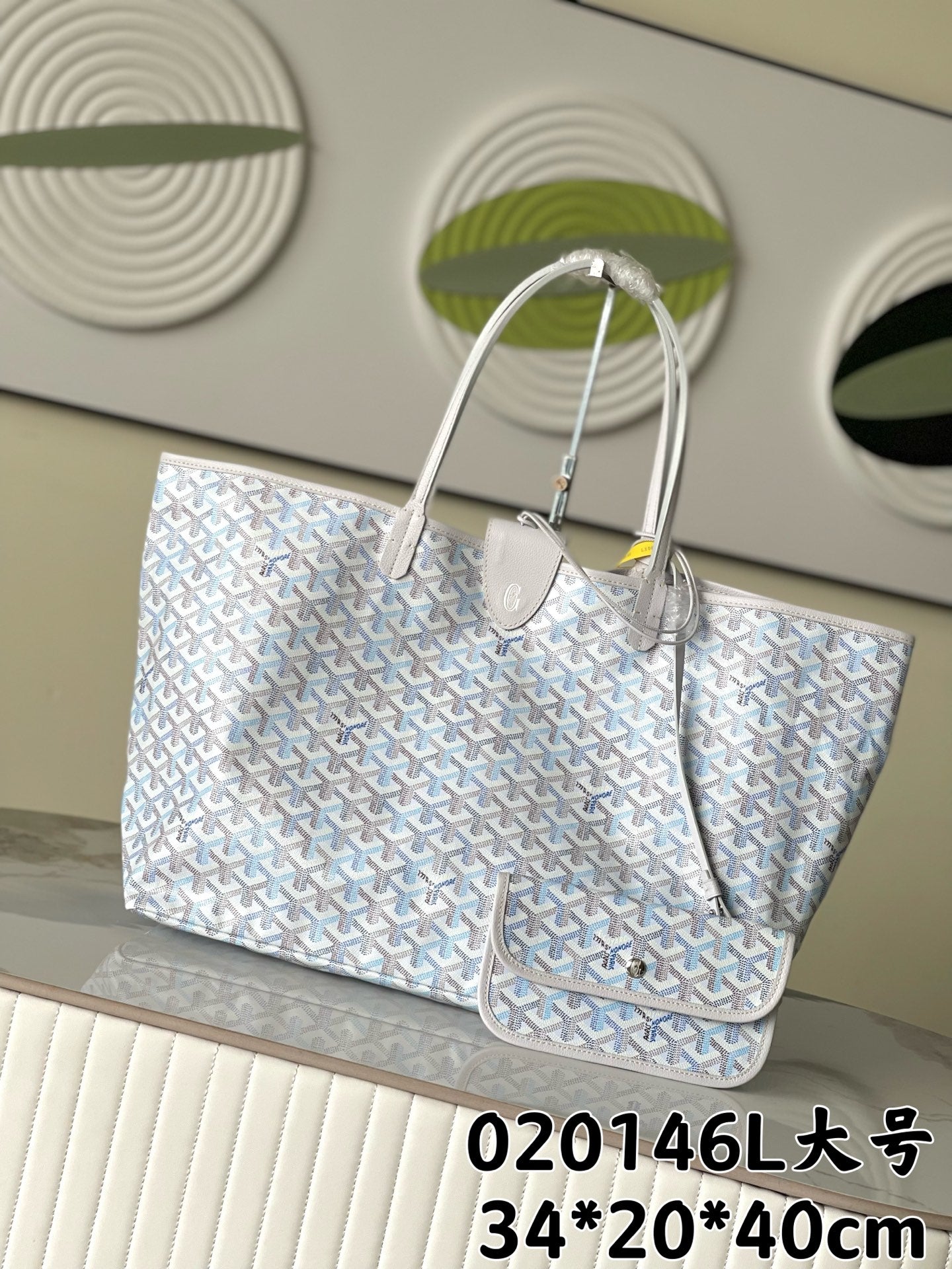 Goyard tote bag in light blue with white pattern, top handles and zip closure