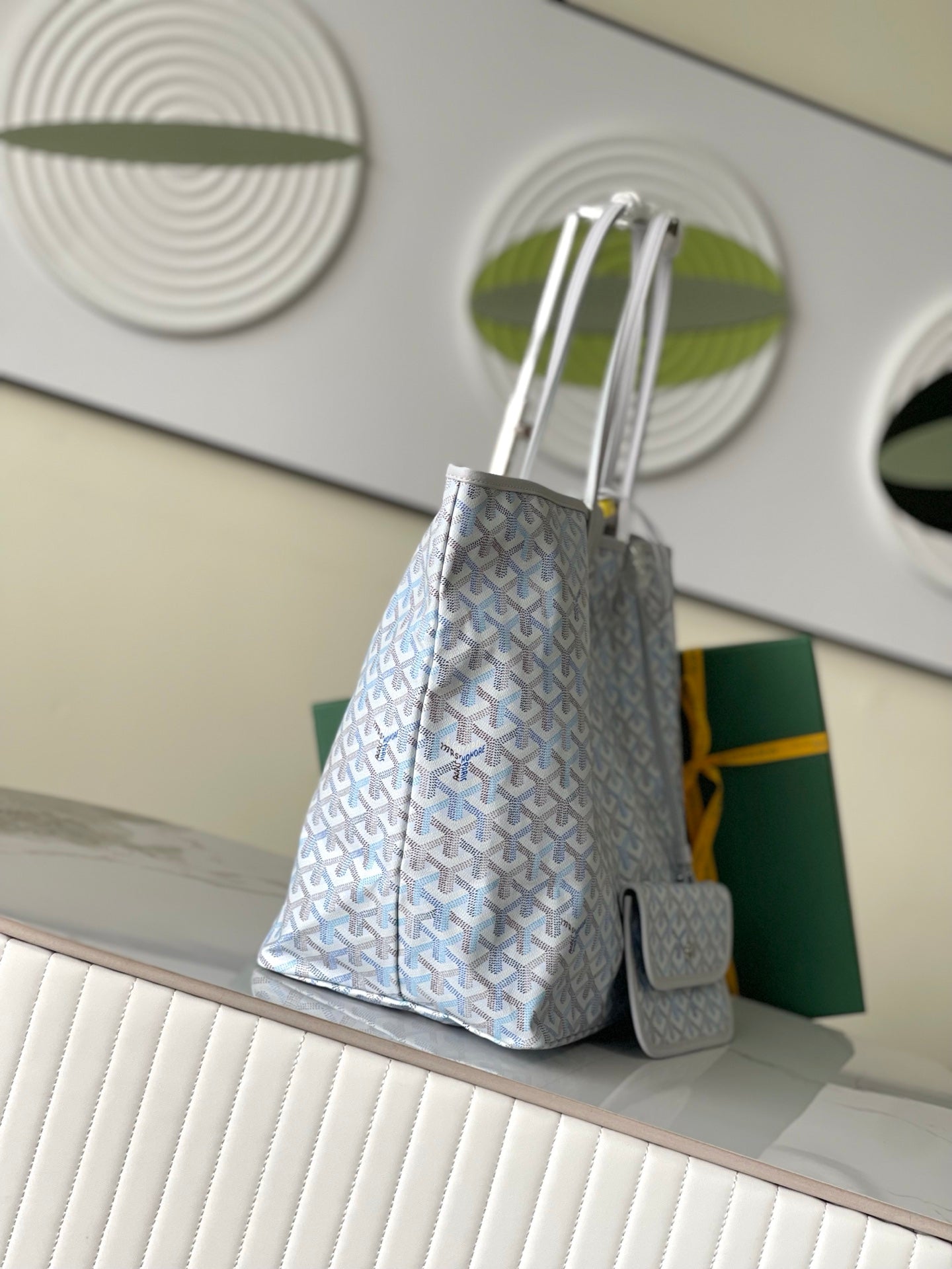 Light blue patterned tote bag with shorter handle, front pouch and side pocket