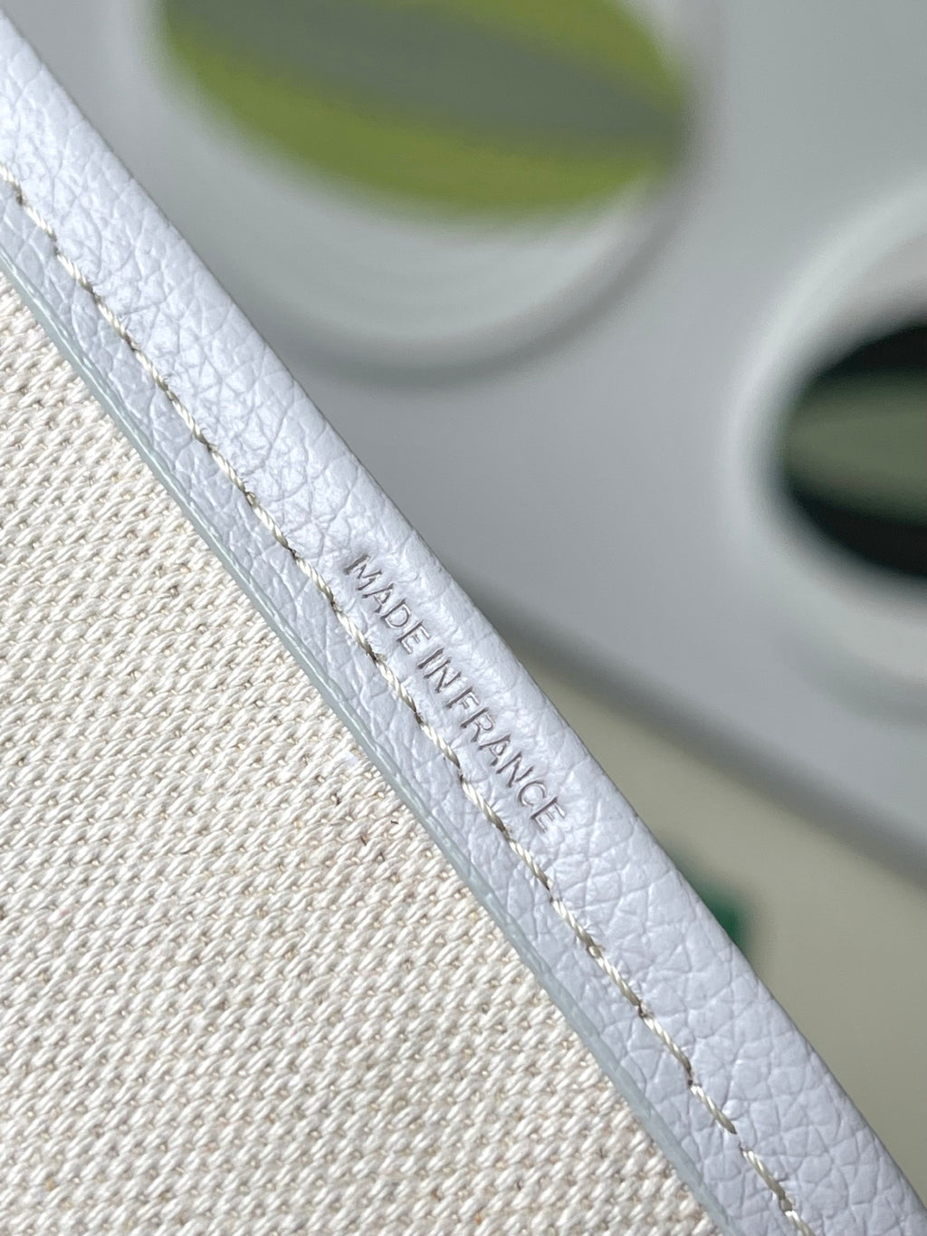 Light blue patterned tote strap with embossed logo and contrast stitching