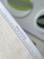 Light blue patterned tote strap with embossed logo and contrast stitching