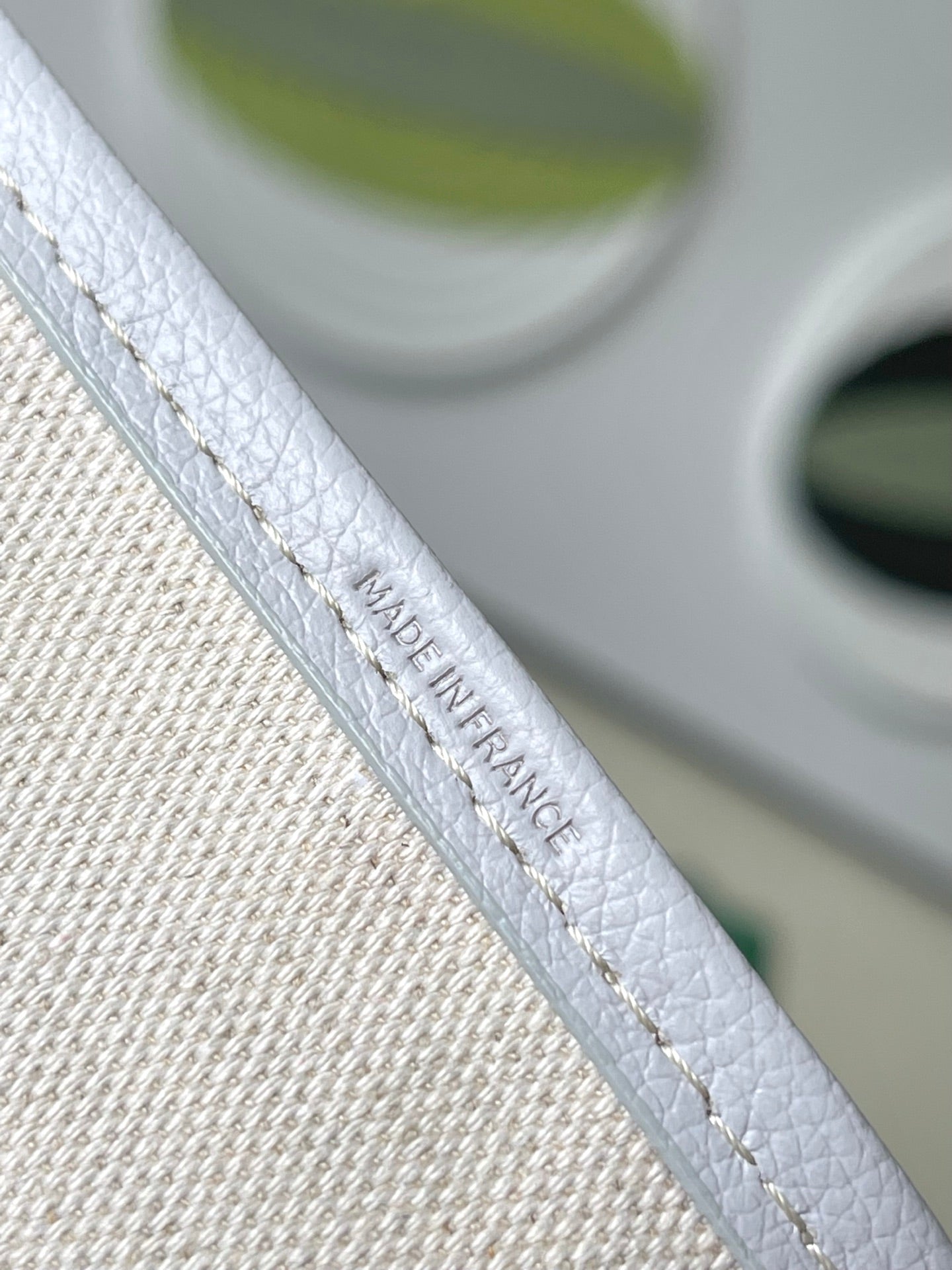Light blue patterned tote strap with embossed logo and contrast stitching