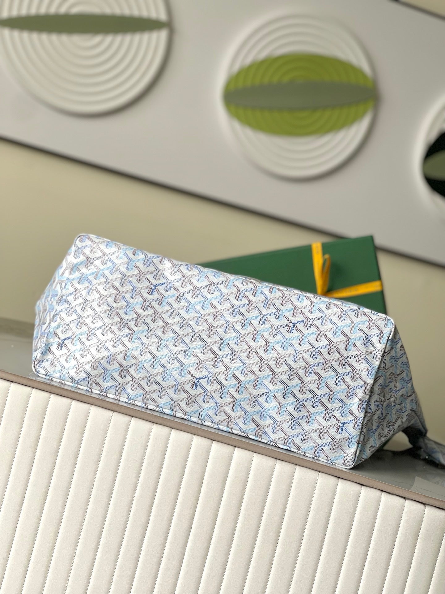 Light blue patterned clutch bag with yellow zipper pull and top clasp
