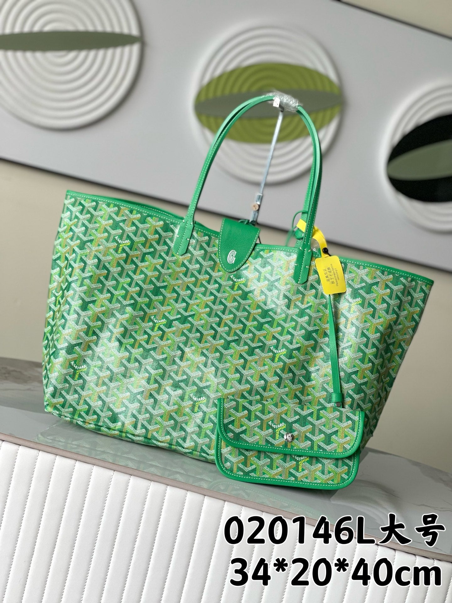 Goyard patterned tote bag with green leather handles and top clasp, mint green canvas
