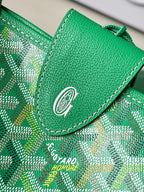 Green patterned tote bag flap with circular emblem and green leather stitching