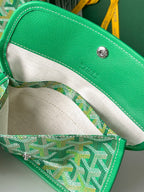 Tote bag interior with cream fabric lining and green leather trim along the opening