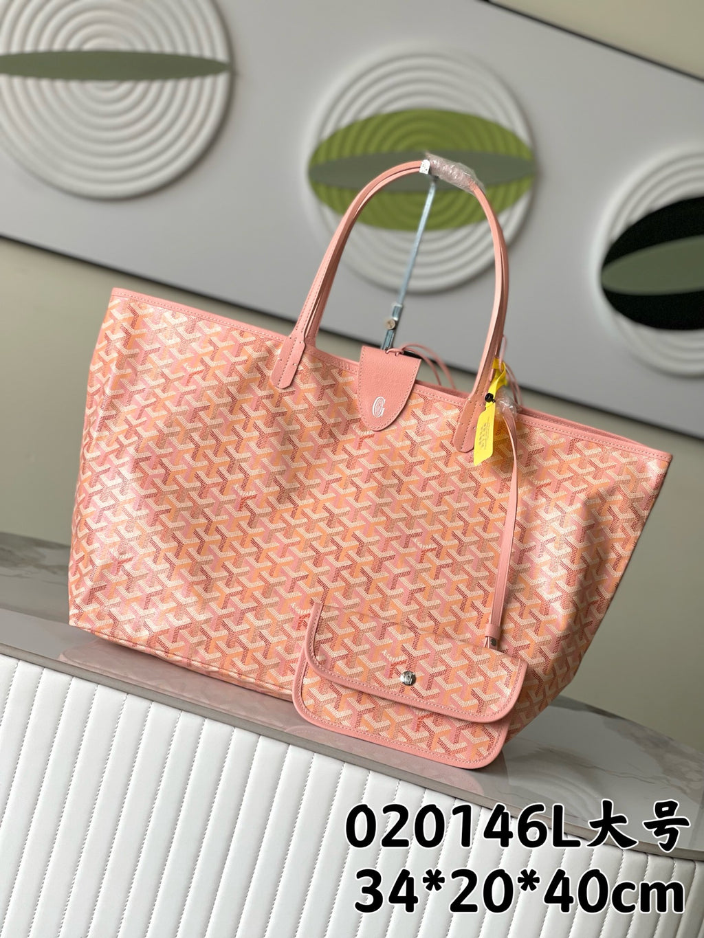 Pink patterned tote bag with top handles and front clasp pocket