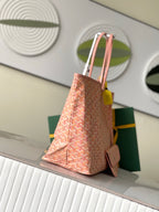Pink patterned tote bag side view with adjustable strap and leather trim