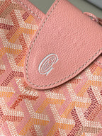 Pink leather trim and embossed logo on patterned tote bag front flap