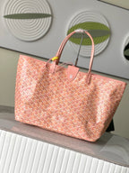 Pink patterned tote bag angled view with top handles and front emblem