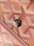 Logo hardware button on patterned pink tote bag with textured trim