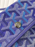 Blue patterned Goyard wallet with snap button and purple leather edging