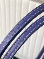 Blue leather carry strap with stitched edging on patterned Goyard bag