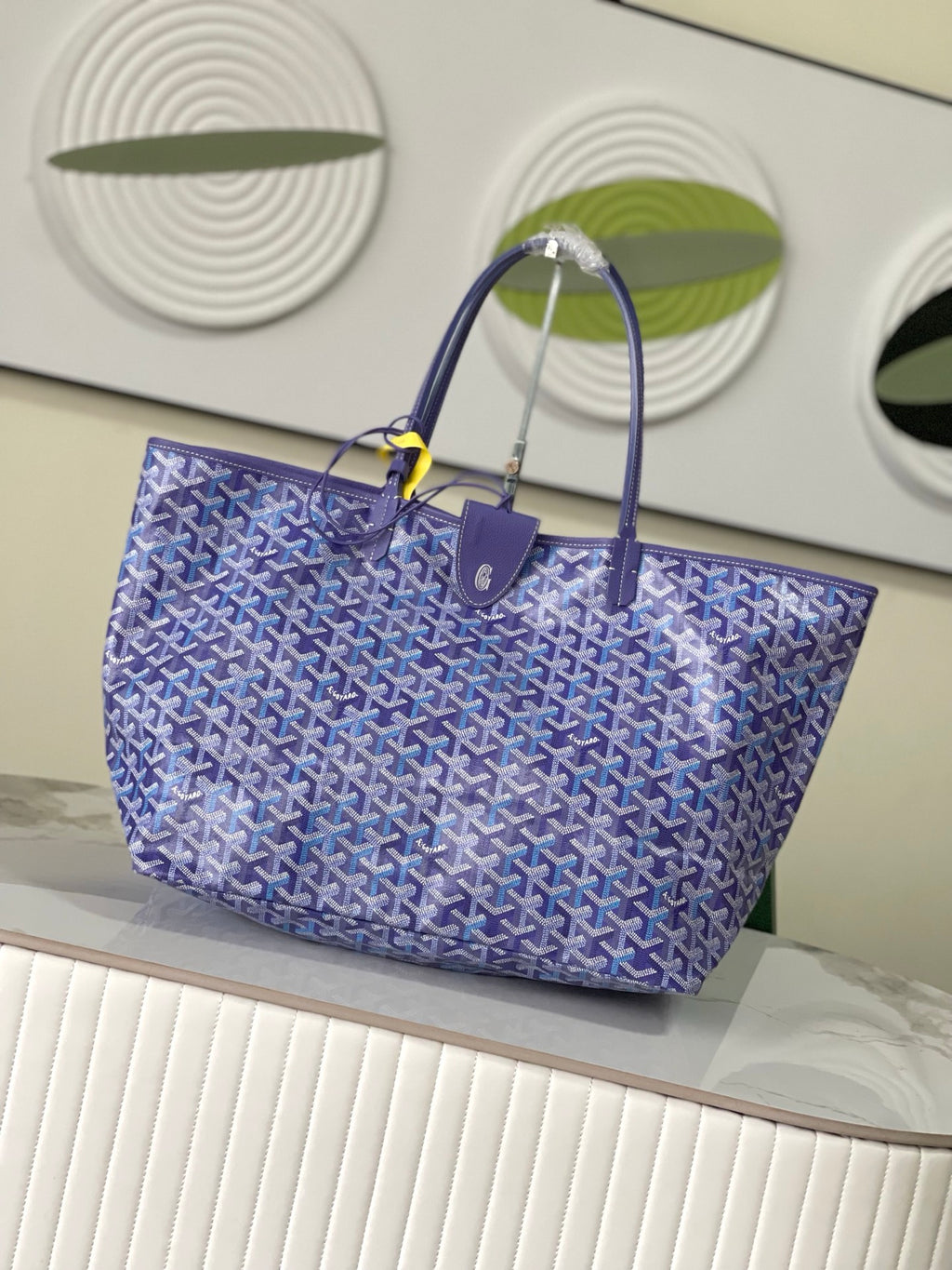 Blue patterned Goyard tote bag with structured shape and top handles
