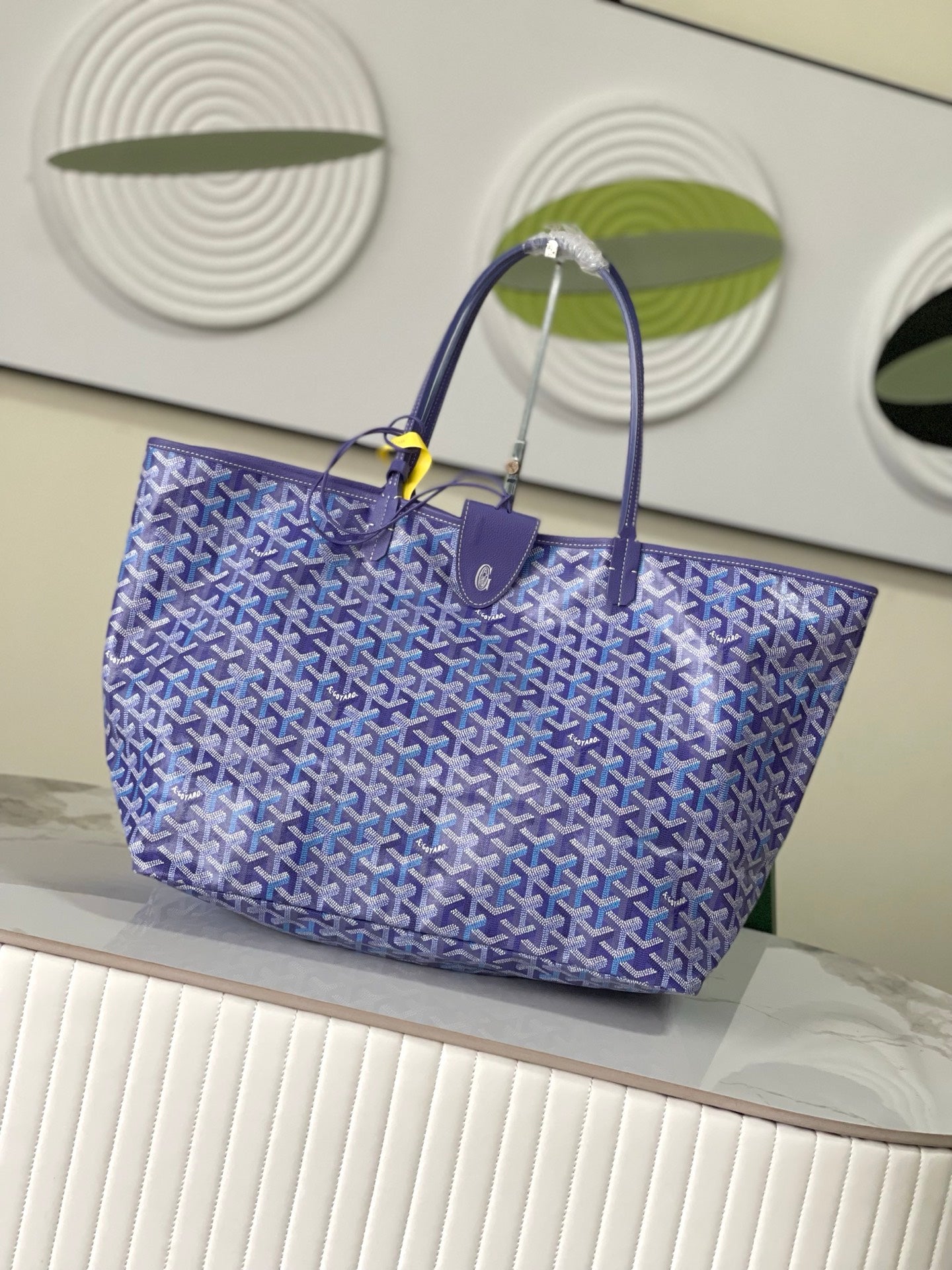 Blue patterned Goyard tote bag with structured shape and top handles