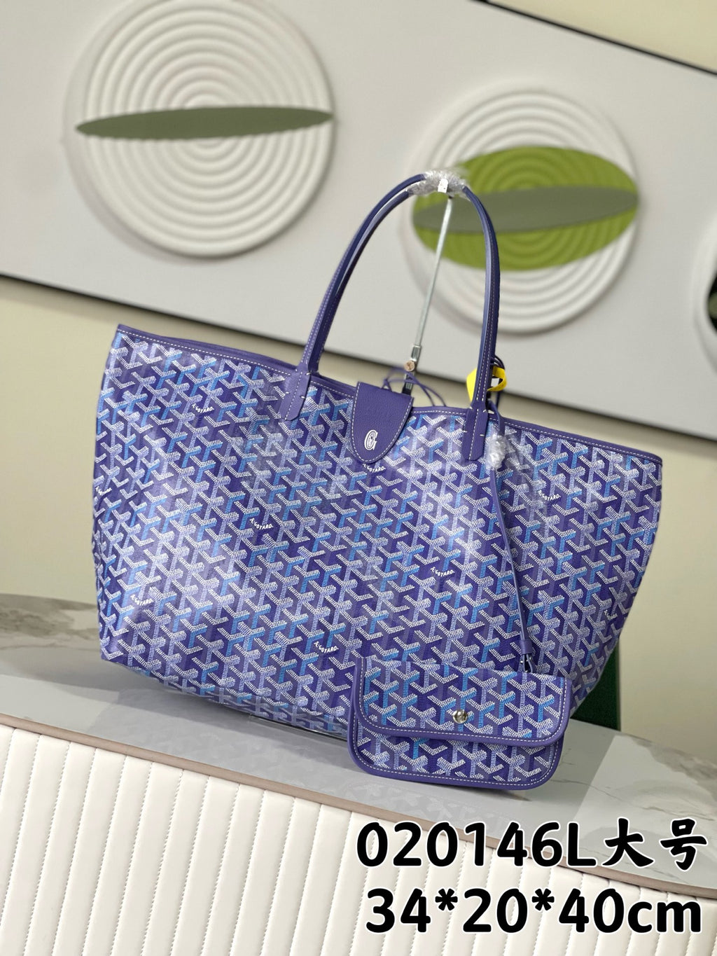 Blue patterned Goyard tote bag with top handles and zip closure