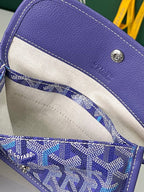 Blue patterned Goyard mini pouch with beige lining and snap closure