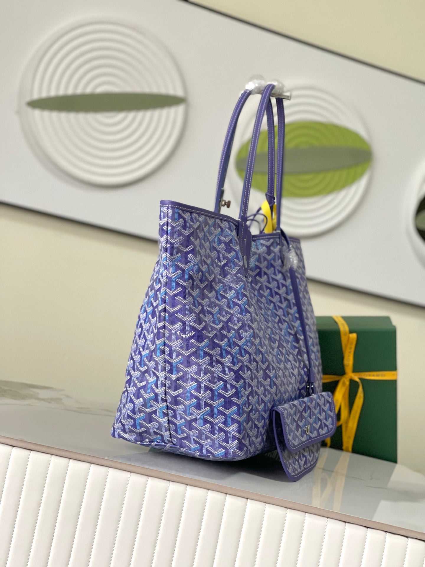 Blue patterned Goyard tote bag with two handles and small matching pouch
