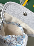 Interior pocket of light blue patterned tote with gray snap button and stitched lining