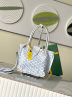 Light blue patterned tote bag with structured gray handles and yellow tag, front view
