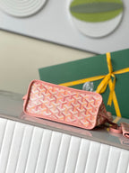 Pink patterned mini pouch with zip top and wrist strap, logo print design.