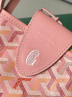 Pink textured pocket flap with circular logo medallion and stitched edge detail.