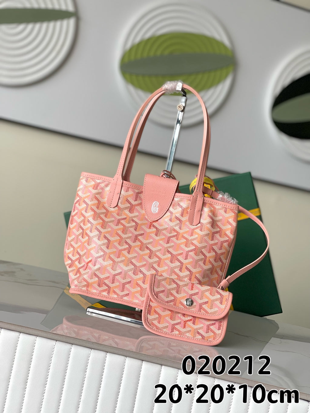 Pink patterned tote bag with top handles and attached small pouch, logo hardware.