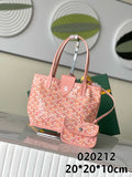 Pink patterned tote bag with top handles and attached small pouch, logo hardware.