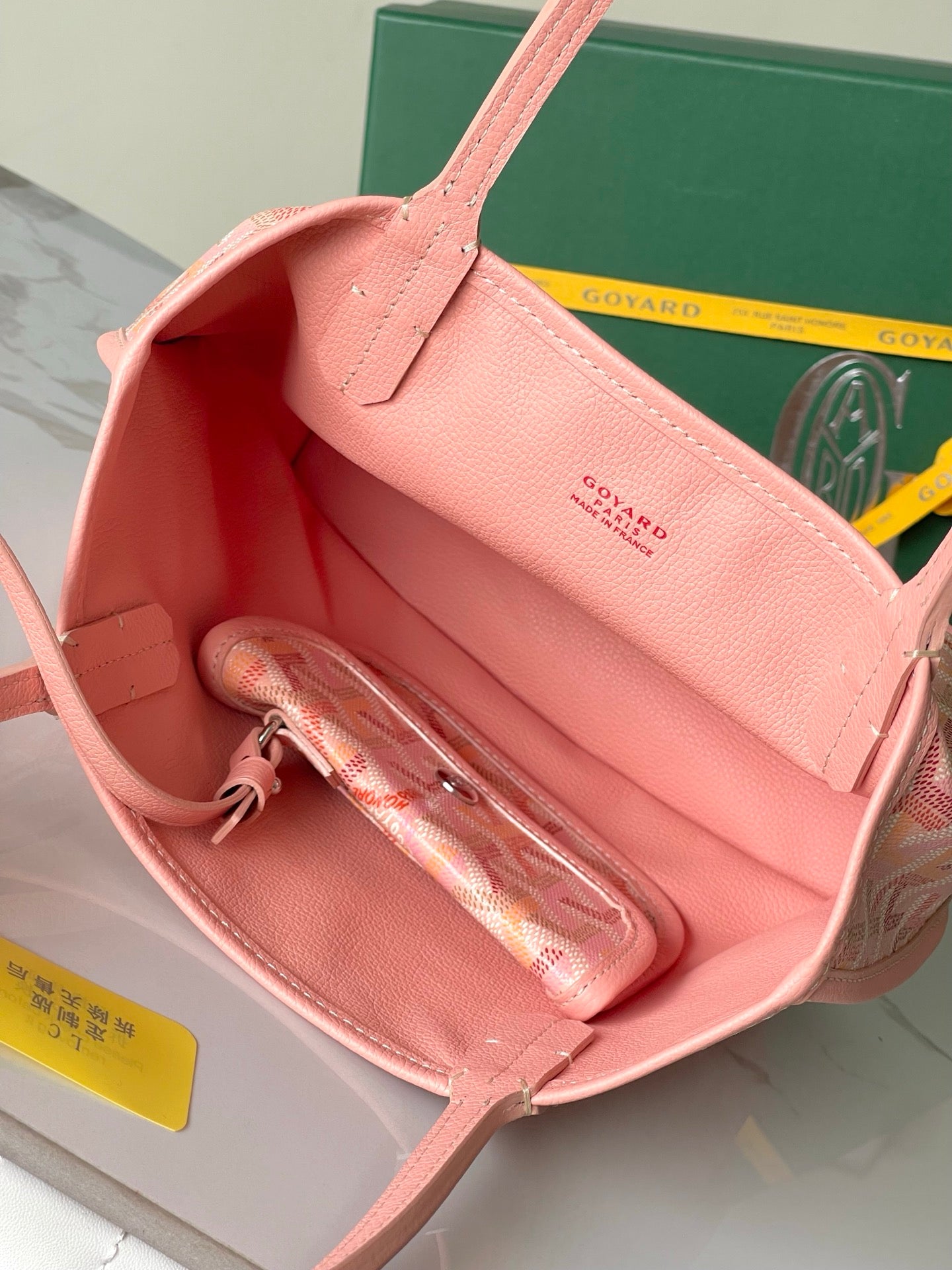 Pink tote bag interior with zipper pouch and open top, showing inner compartments.