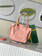 Pink patterned tote bag with top handles, side view, and small accessory at front.
